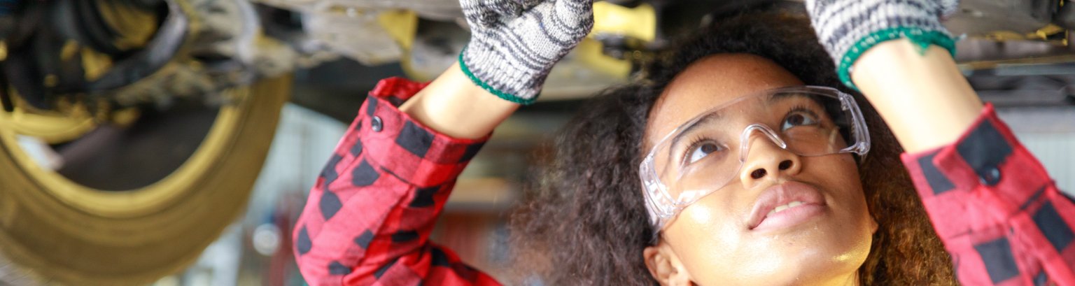 Female auto mechanic working at the repair shop. Female auto mechanic working at the repair shop.