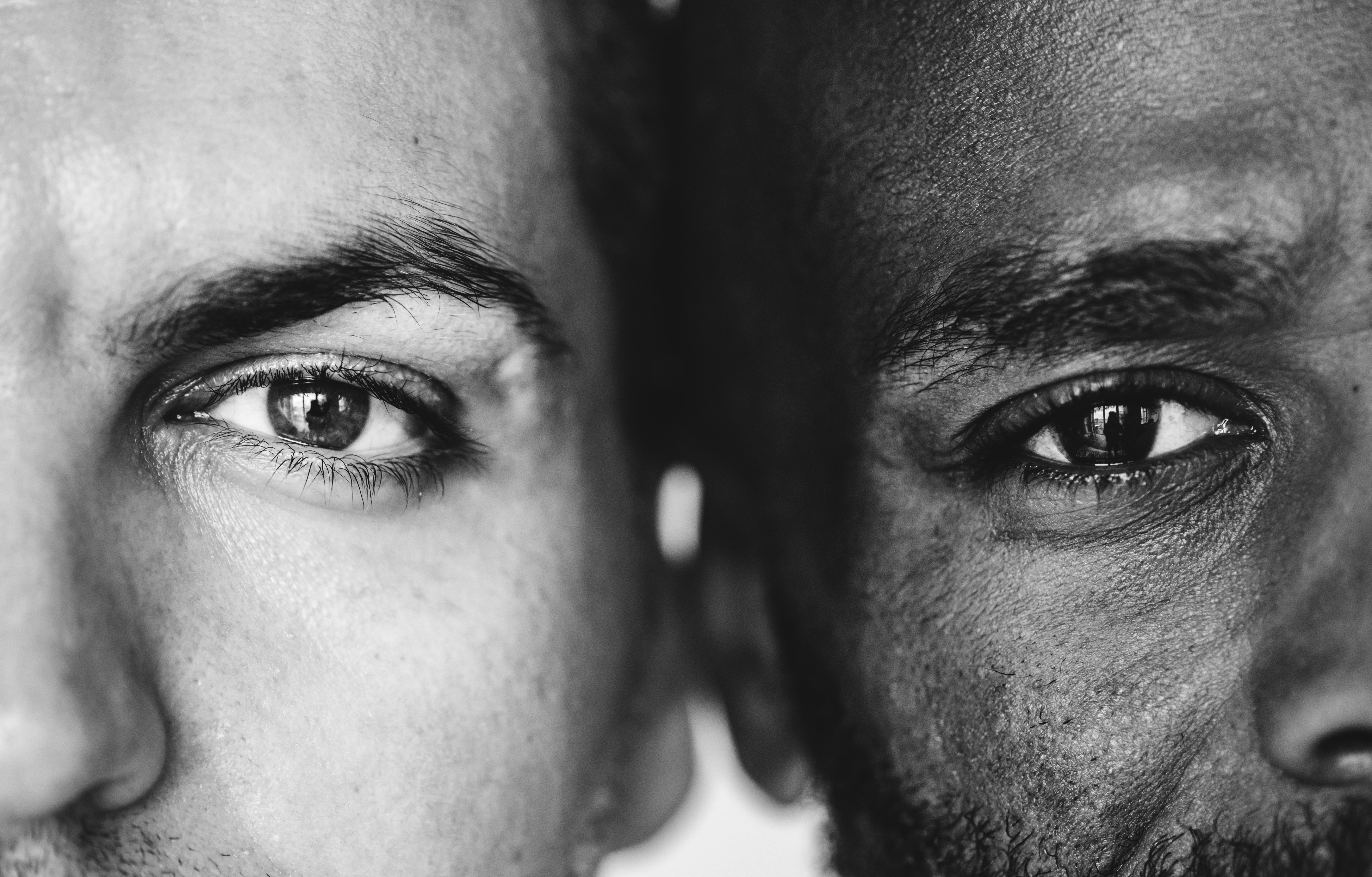 Two different ethnic men&#39;s eyes closeup