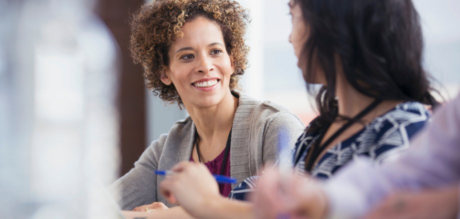 Adult woman having a conversation in classroom.